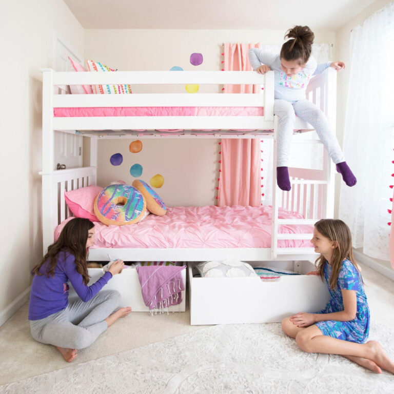 Max And Lily Twin Over Twin Bunk Bed With Storage White Kids Playing Max and Lily Twin Over Twin Bunk Bed With Storage in White - three children playing in a pink-themed bedroom, one climbing down from the top bunk while the under-bed storage drawers are open.