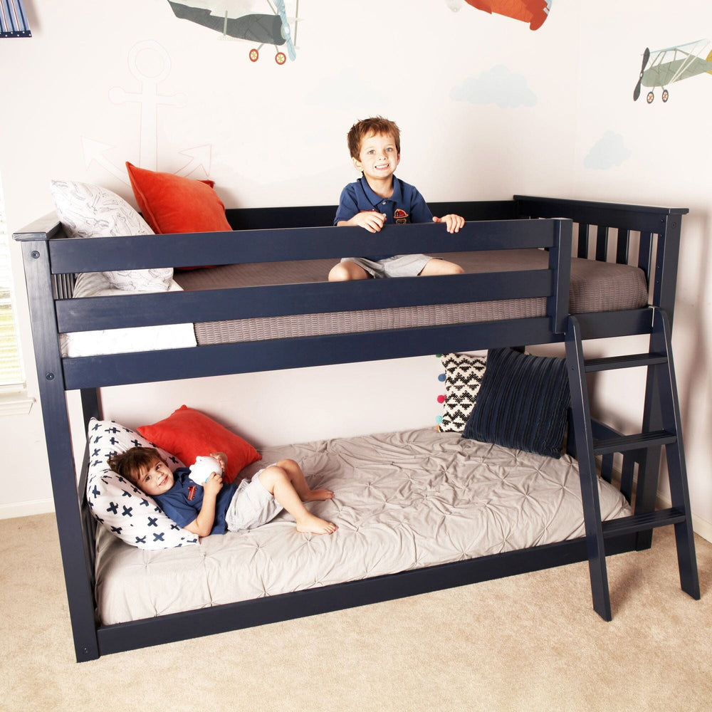 Max And Lily Twin over Twin Low Bunk Bed in Blue - two children relaxing on the top and bottom bunks in a decorated bedroom