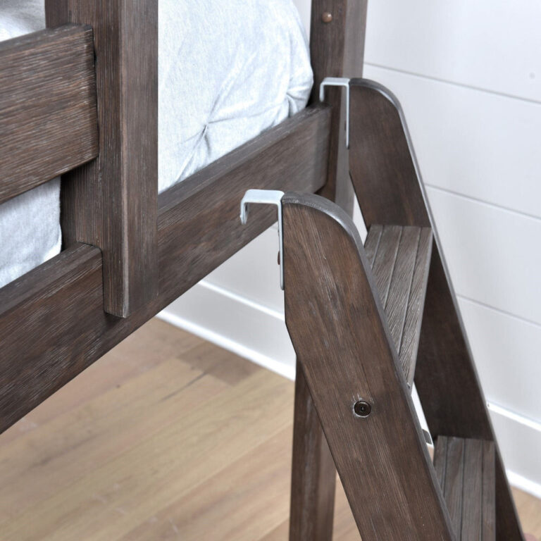 Max And Lily Twin over Twin Low Bunk Bed in clay - closeup of the metal ladder hooks securing the angled ladder to the top bunk rail, with grooved anti-slip steps