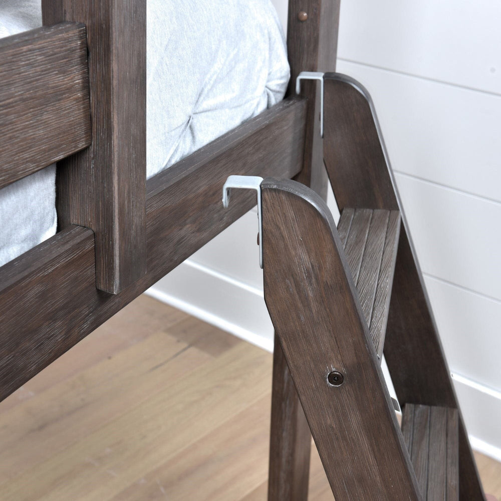 Max And Lily Twin over Twin Low Bunk Bed in clay - closeup of the metal ladder hooks securing the angled ladder to the top bunk rail, with grooved anti-slip steps