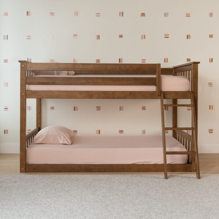 Max And Lily Twin over Twin Low Bunk Bed in Pecan - straight-on side view in a bedroom showing the low bunk height, upper guardrails and ladder at the foot of the bed