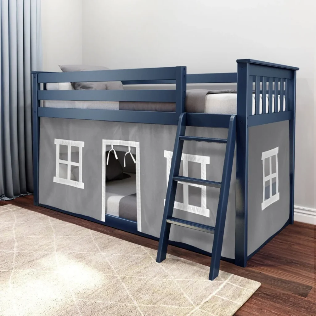 Max and Lily Twin Over Twin Low Bunk Bed With Curtain in Grey/Blue - low bunk bed with playhouse curtain featuring window and door openings, angled ladder and safety guardrails, styled in a kids bedroom with a rug