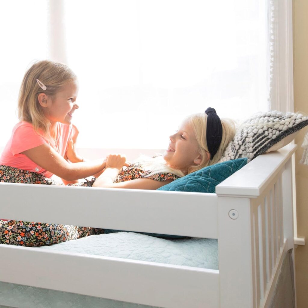 Max And Lily Twin Over Twin Low Bunk Bed With Curtain Kids Playing 2 Max and Lily Twin Over Twin Low Bunk Bed With Curtain - two young girls playing together on the top bunk beside a bright window