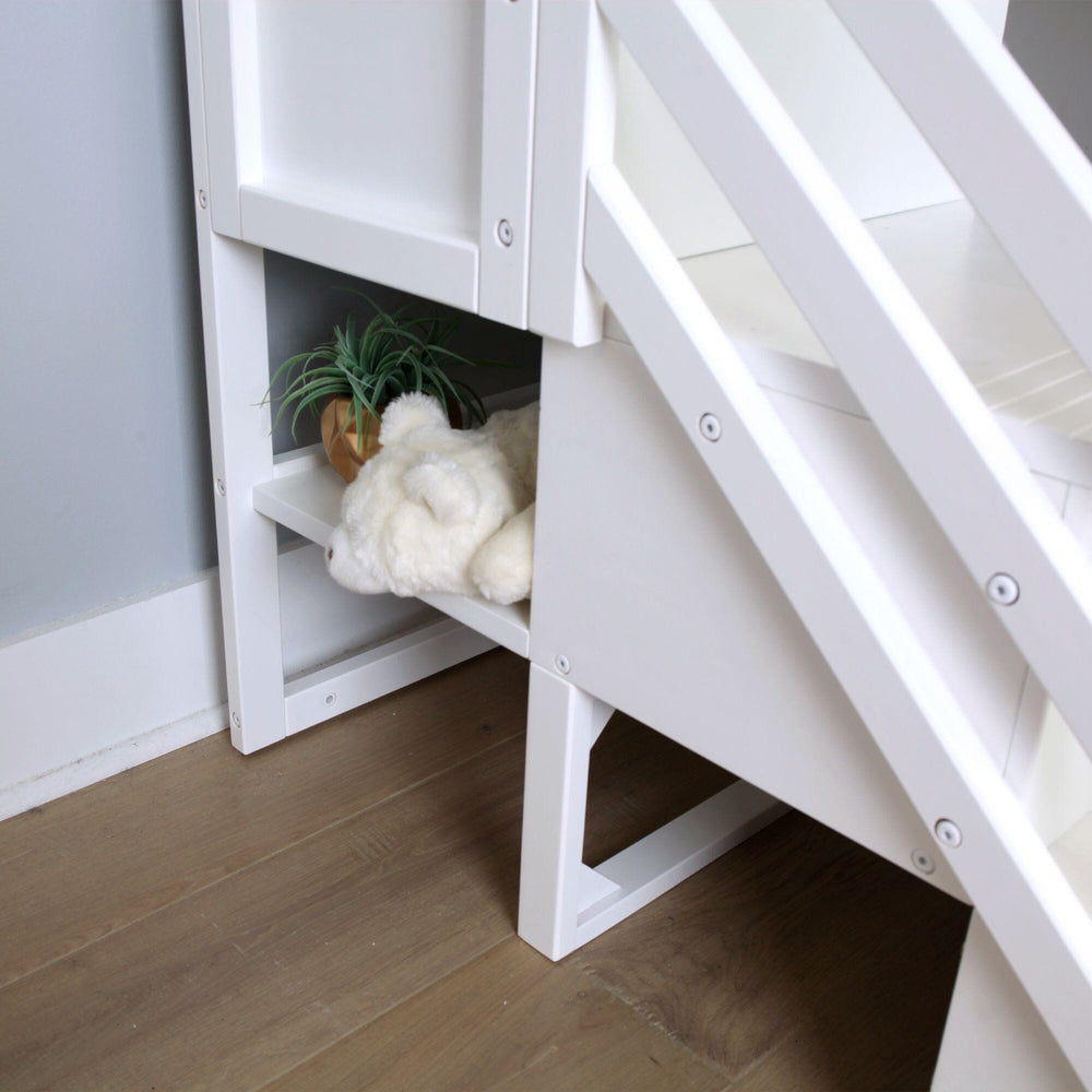 Max and Lily Twin Over Twin Low Bunk Bed With Staircase & Curtain in White Blue/White - close-up of the built-in staircase storage shelf holding a plush toy and a plant