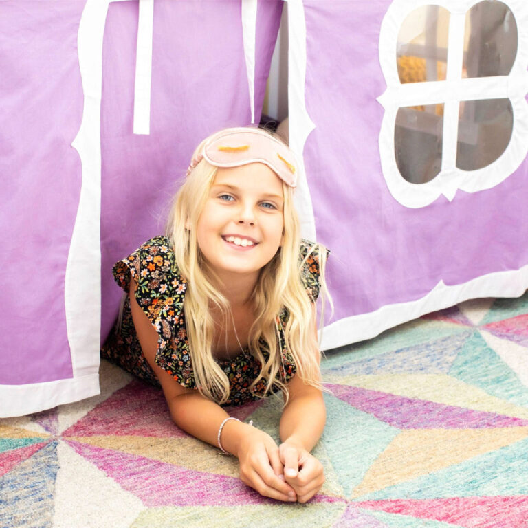 Max And Lily Twin Over Twin Low Bunk Bed With Staircase Curtain White Purple White Kids Playing Max and Lily Twin Over Twin Low Bunk Bed With Staircase & Curtain in White Purple/White - a smiling child lying beneath the bed inside the purple curtain play tent.