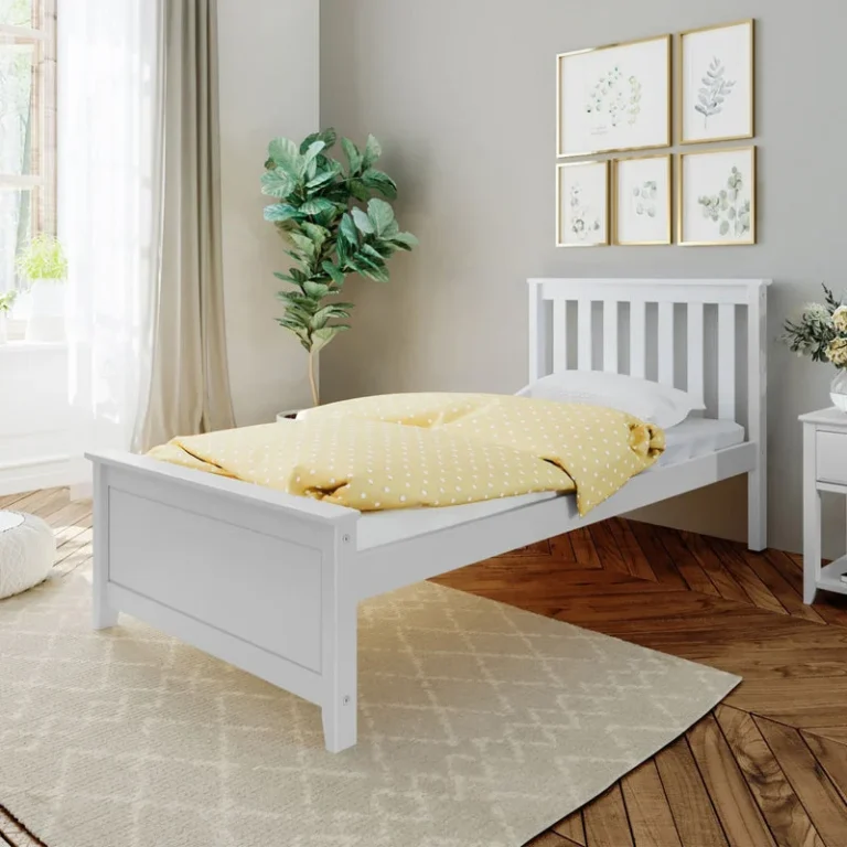 Max and Lily Twin Platform Bed with Slatted Headboard in White - angled view in a bright bedroom with yellow polka-dot bedding, a potted plant, and a patterned area rug