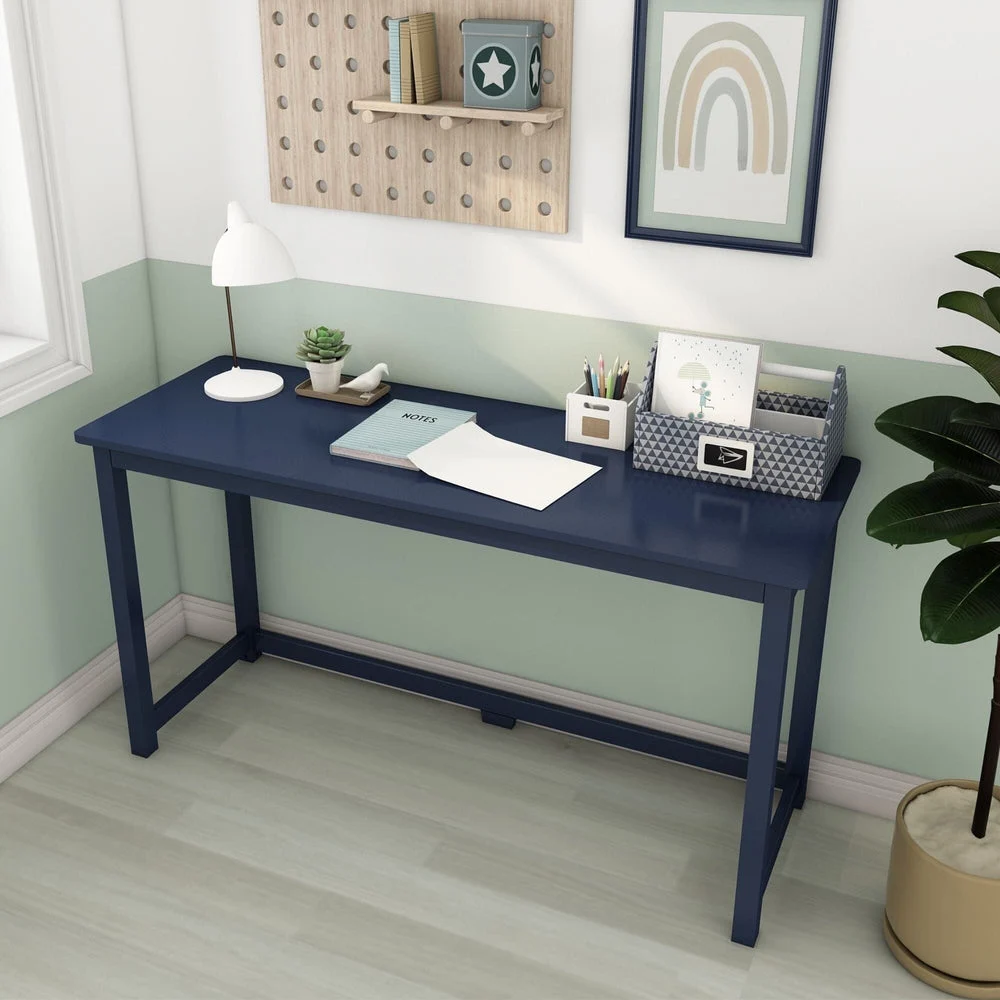 Max and Lily Writing Desk in Blue - styled in a kids' room with a desk lamp, potted plant and a pegboard wall organizer above.