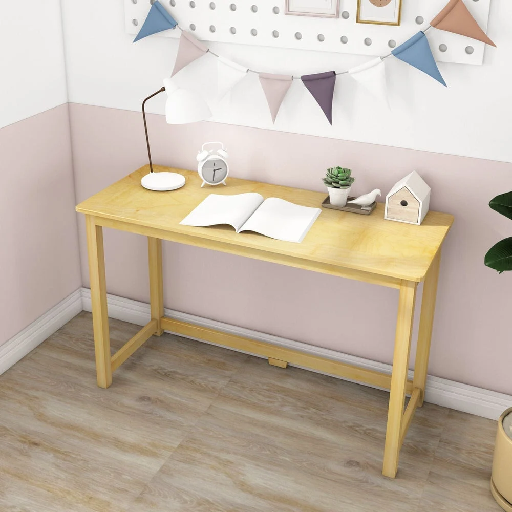 Max and Lily Writing Desk in Natural - styled in a pastel kids room with a desk lamp, alarm clock, and pegboard wall decor