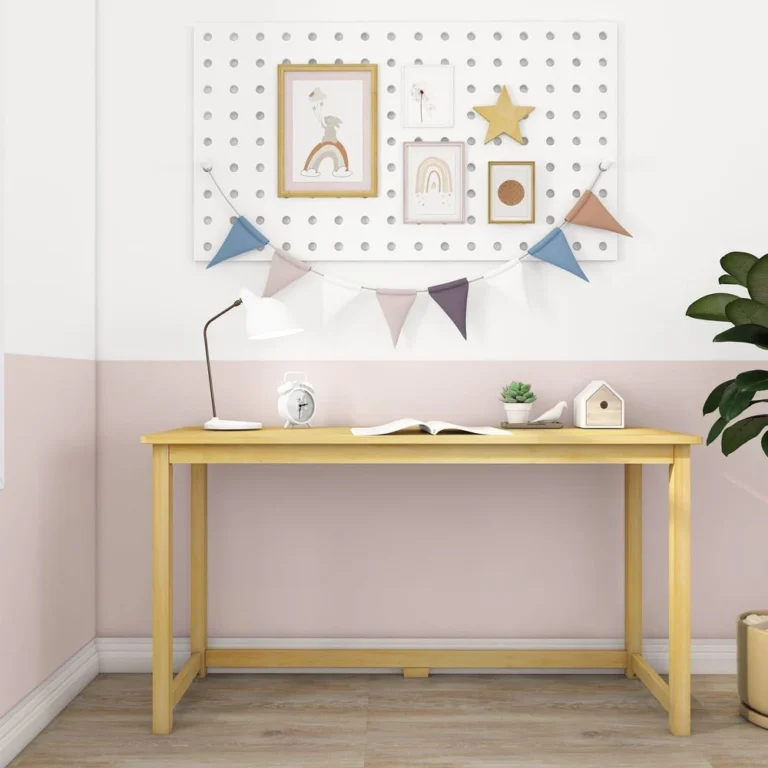Max and Lily Writing Desk in Natural - front view styled in a pink kids' room with a desk lamp, potted plant, and decorative pegboard.