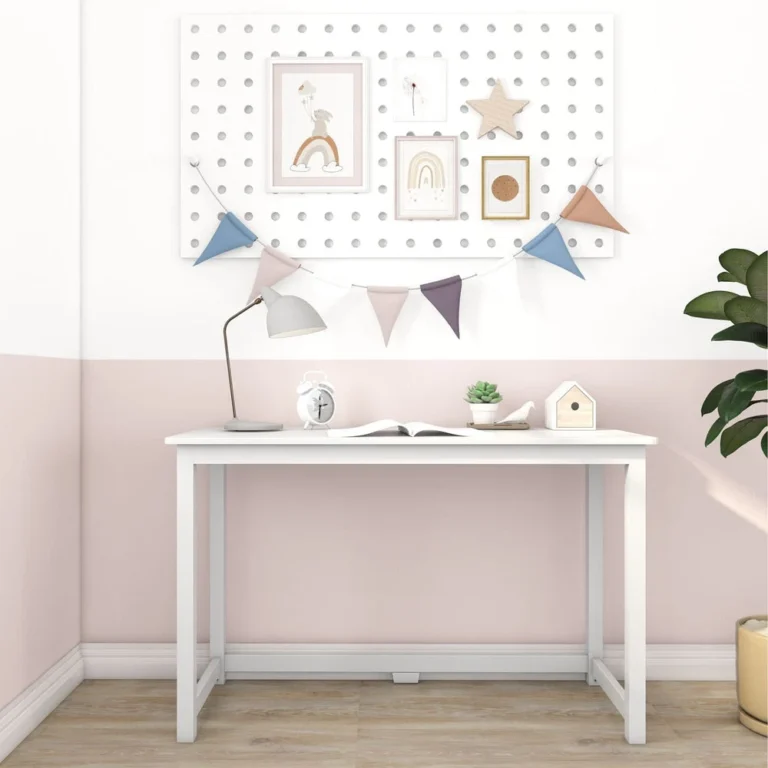 Max and Lily Writing Desk in White - shown front-on against a pink wall with a decorative pegboard, desk lamp and books