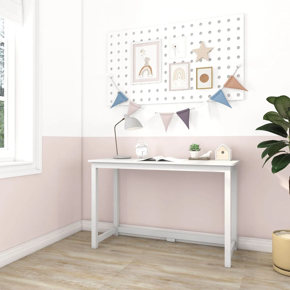 Max and Lily Writing Desk in White - angled room scene beside a window with a pegboard and bunting on the wall above