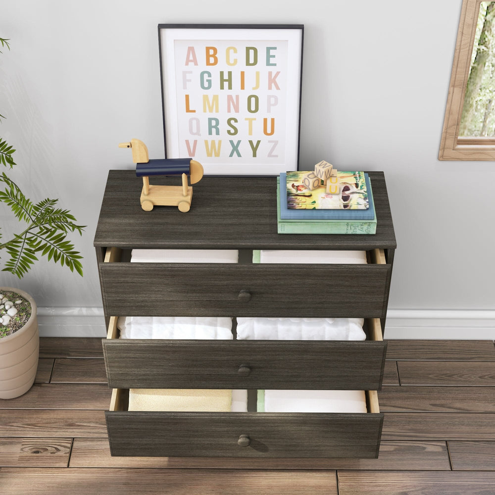 Max & Lily Classic 3 Drawer Dresser in Clay - styled room scene with all three drawers pulled open showing stored linens inside.