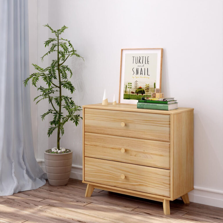Max Lily Classic 3 Drawer Dresser Natural Room Scene 1 Max & Lily Classic 3 Drawer Dresser in Natural - styled in a bedroom beside a potted plant with framed art and books on top