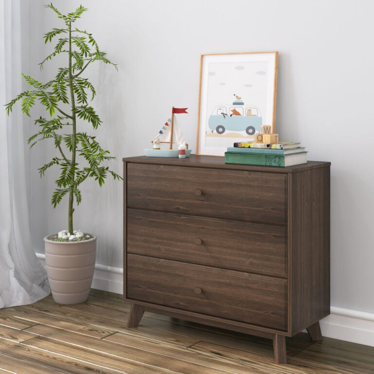 Max Lily Classic 3 Drawer Dresser Walnut Room Scene 1 Max & Lily Classic 3 Drawer Dresser in Walnut - styled in a nursery beside a tall potted plant with framed artwork, a toy sailboat and books arranged on top.