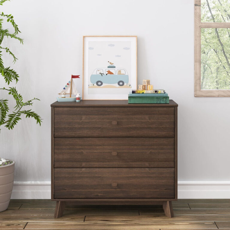Max Lily Classic 3 Drawer Dresser Walnut Room Scene 2 Max & Lily Classic 3 Drawer Dresser in Walnut - shown in a bright room next to a window with framed art and stacked books displayed on top.