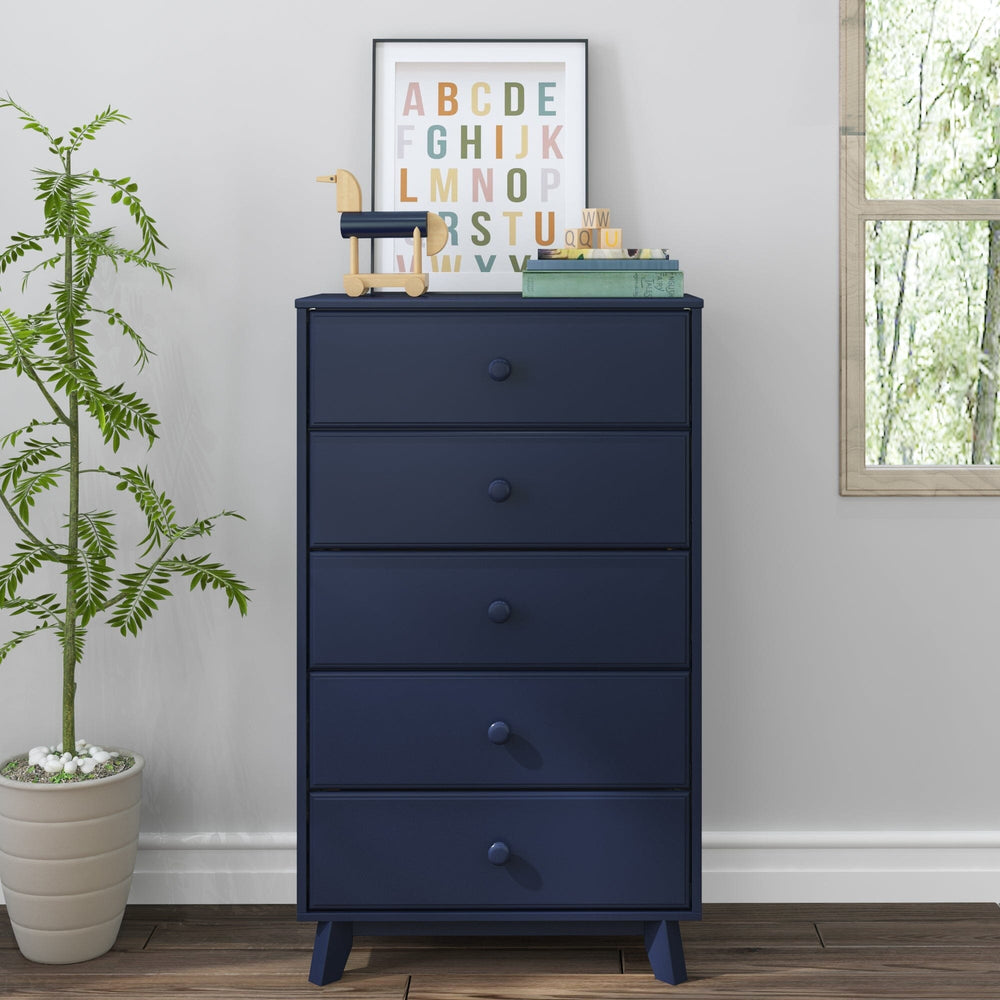 Max & Lily Classic 5 Drawer Dresser in Blue - front view in a nursery with a potted plant, window, and framed alphabet print.