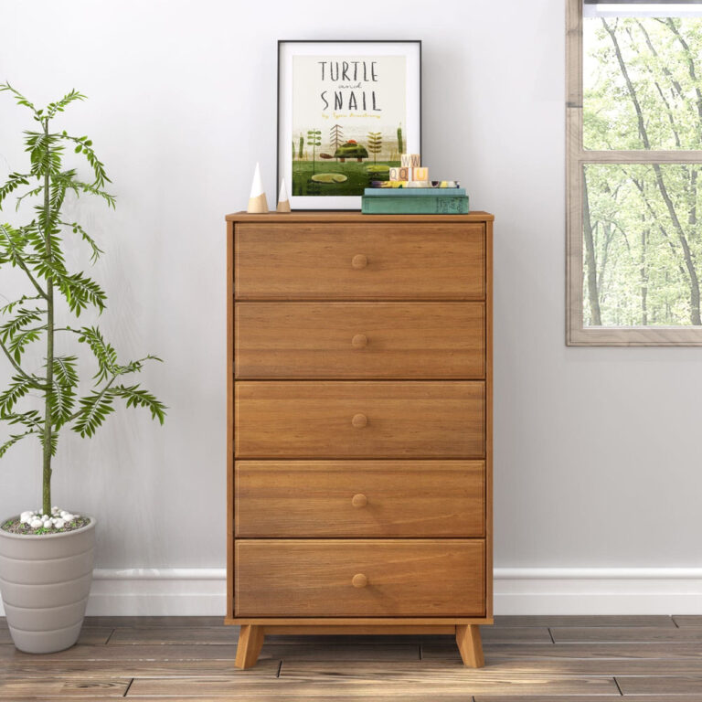 Max Lily Classic 5 Drawer Dresser Pecan Room Scene 2 Max & Lily Classic 5 Drawer Dresser in Pecan - front view in a room next to a window and potted plant with framed art on top.