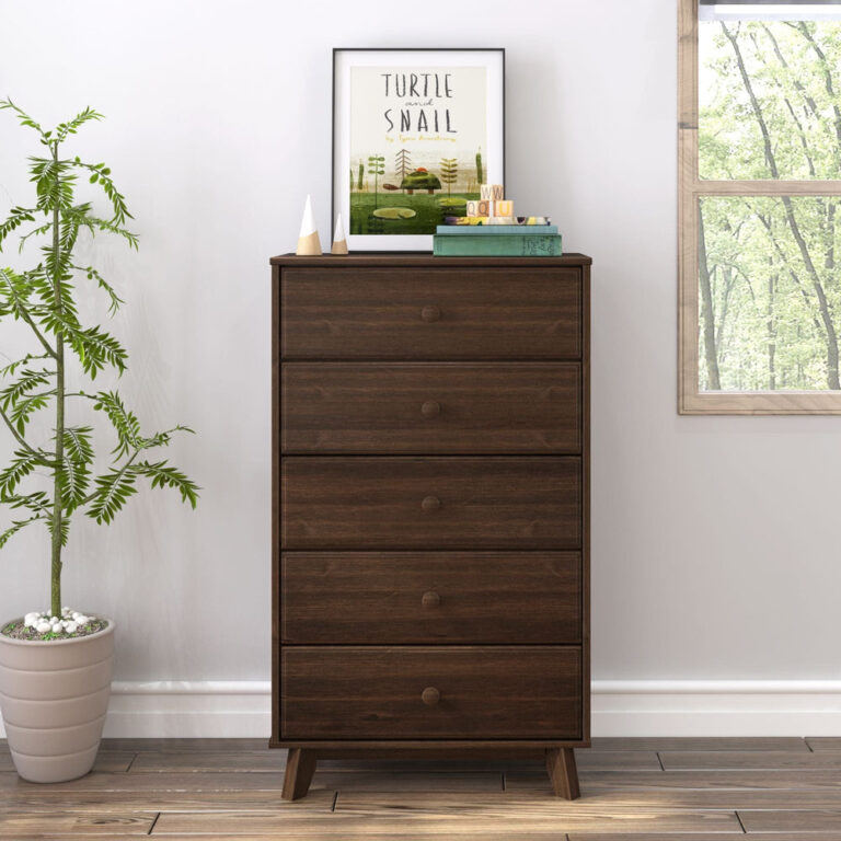 Max Lily Classic 5 Drawer Dresser Walnut Room Scene 2 Max & Lily Classic 5 Drawer Dresser in Walnut - front view in a bright bedroom beside a potted plant and window with books and framed art on top.