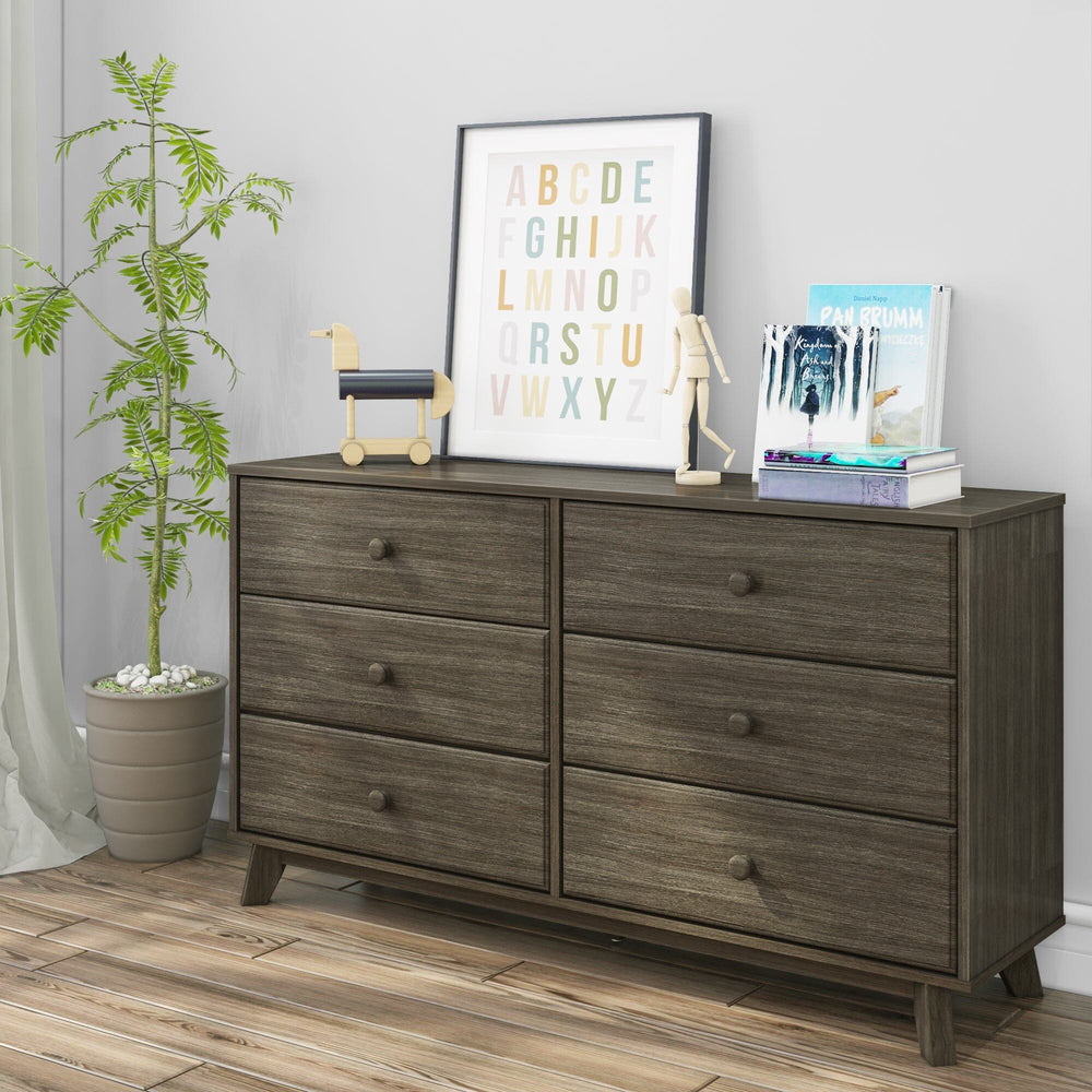Max Lily Classic 6 Drawer Dresser Clay Room Scene 1 Max & Lily Classic 6 Drawer Dresser in Clay - angled view styled in a child's room with a potted plant, framed alphabet print, books, and a wooden toy on top.