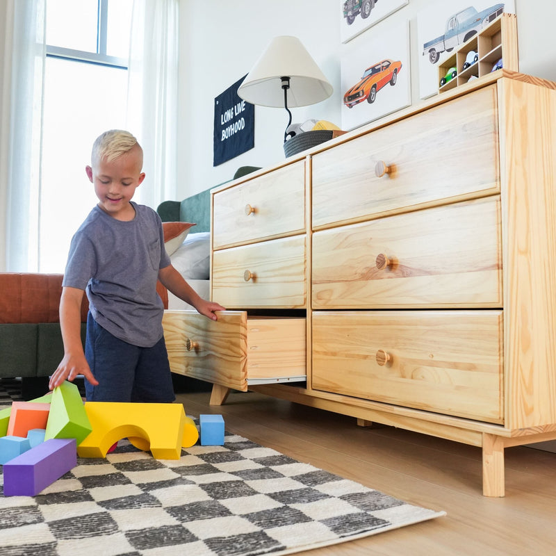 Max Lily Classic 6 Drawer Dresser Natural Child Opening Drawer Max & Lily Classic 6 Drawer Dresser in Natural - a young boy pulling open a lower drawer in a playroom with building blocks on the floor.