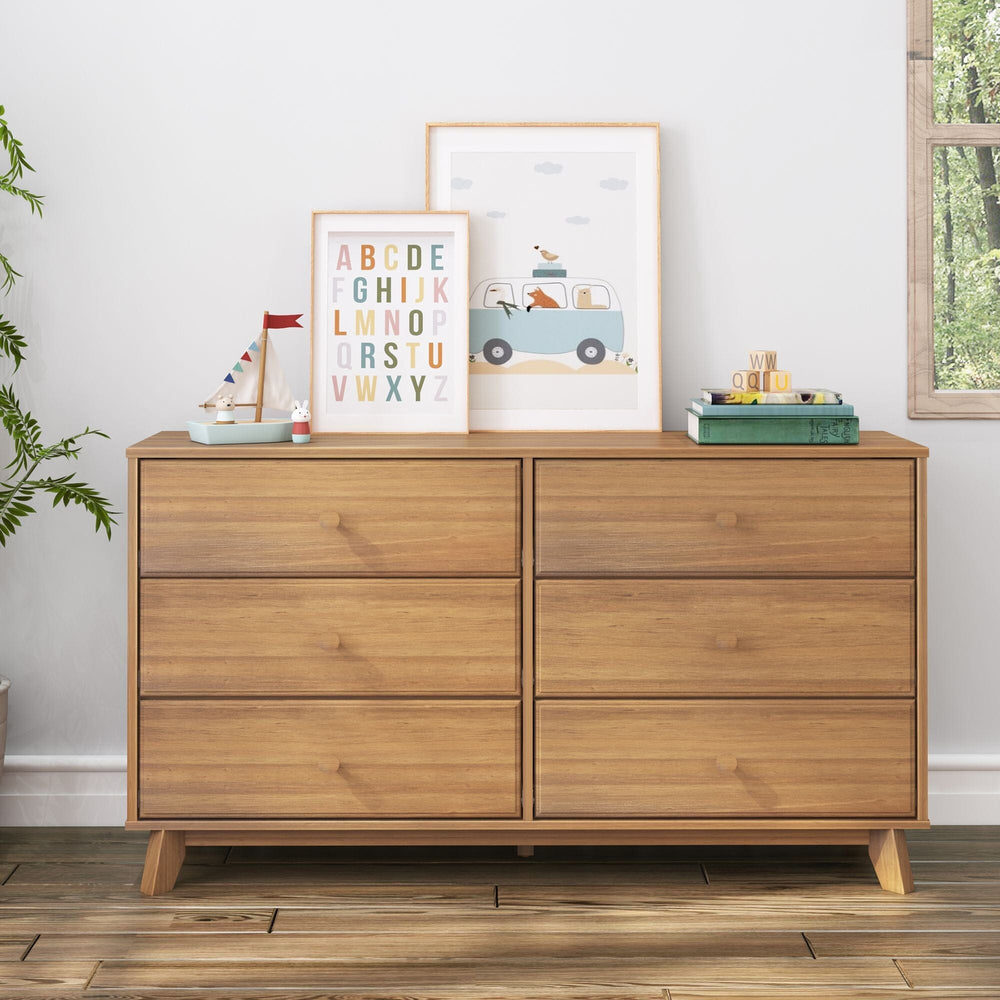 Max & Lily Classic 6 Drawer Dresser in Pecan - staged against a white wall with framed alphabet prints, a toy sailboat, books, and a plant.