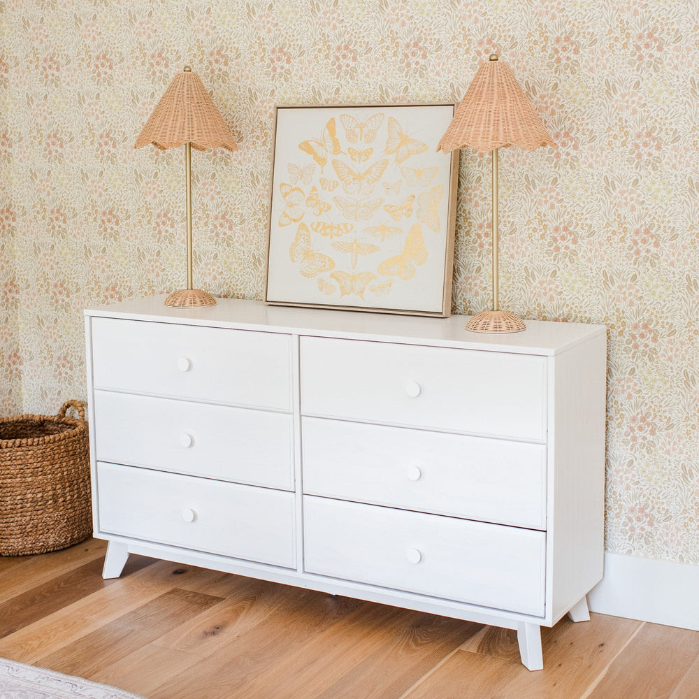Max Lily Classic 6 Drawer Dresser White Room Scene Max & Lily Classic 6 Drawer Dresser in White - styled in a nursery with floral wallpaper, two rattan lamps, and framed butterfly wall art.