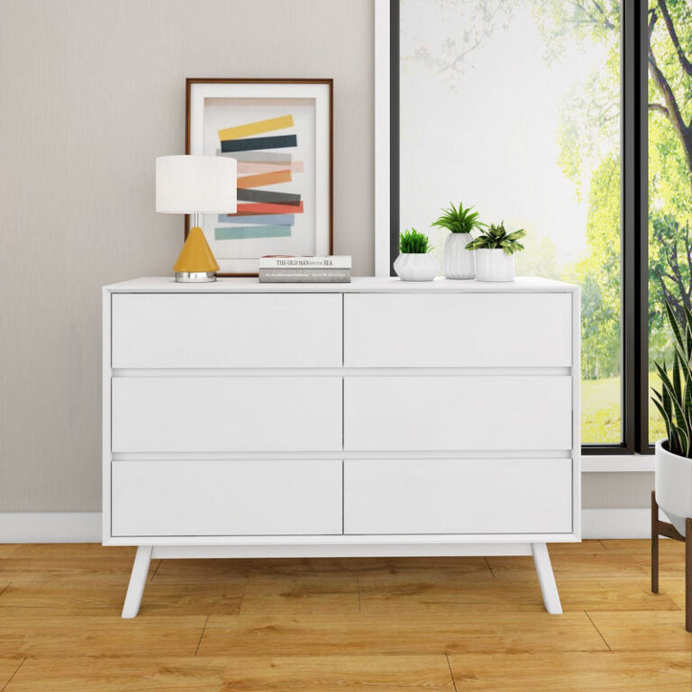 Max Lily Mid Century Modern 6 Drawer Dresser White Room Scene 2 Max & Lily Mid Century Modern 6 Drawer Dresser in White - shown beside a sunlit window with a lamp, framed print, and plants on top.