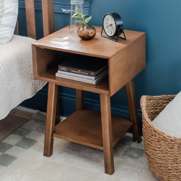Max Lily Mid Century Modern Cubby Night Stand Pecan Room Scene 1 Max & Lily Mid-Century Modern Cubby Night Stand in Pecan - styled beside a bed with books in the open cubby and a clock and vase on top.