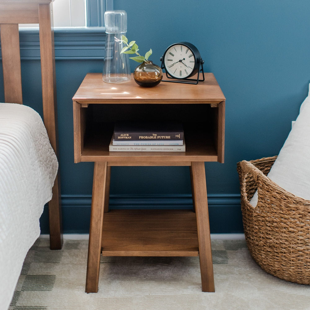 Max & Lily Mid-Century Modern Cubby Night Stand in Pecan - front view in a bedroom showing the open cubby shelf and lower storage shelf.