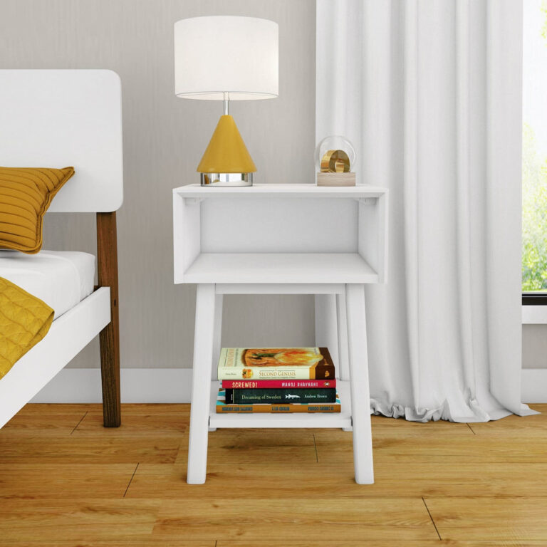Max Lily Mid Century Modern Cubby Night Stand White Room Scene 2 Max & Lily Mid-Century Modern Cubby Night Stand in White - placed next to a bed with a lamp on top and books on the open lower shelf.
