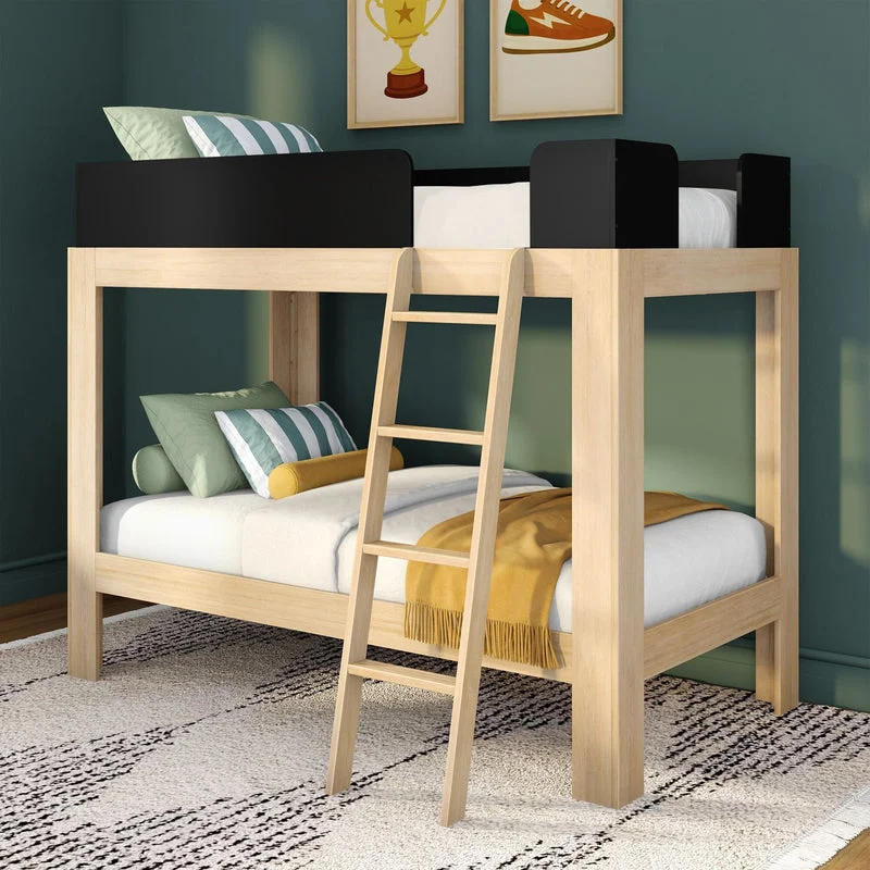 Max & Lily Mid-Century Modern Twin Over Twin Bunk Bed in Blonde/Black - angled ladder and black safety guardrails, styled in a kids' room with a teal wall, patterned rug and a mustard throw blanket