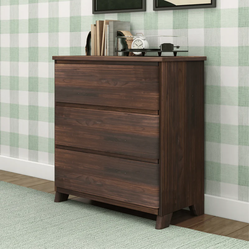 Max & Lily Modern Farmhouse 3 Drawer Dresser in Barnwood Brown - angled view in a room setting showing the solid wood side panel and tapered legs