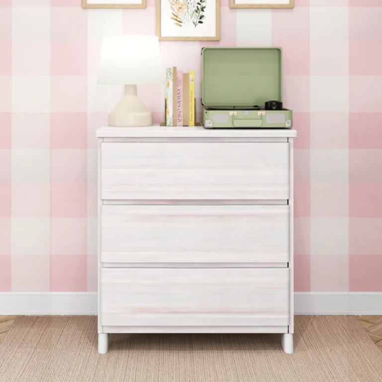 Max & Lily Modern Farmhouse 3 Drawer Dresser in White Wash - front view in a kids bedroom, styled with a lamp, books and a record player on top
