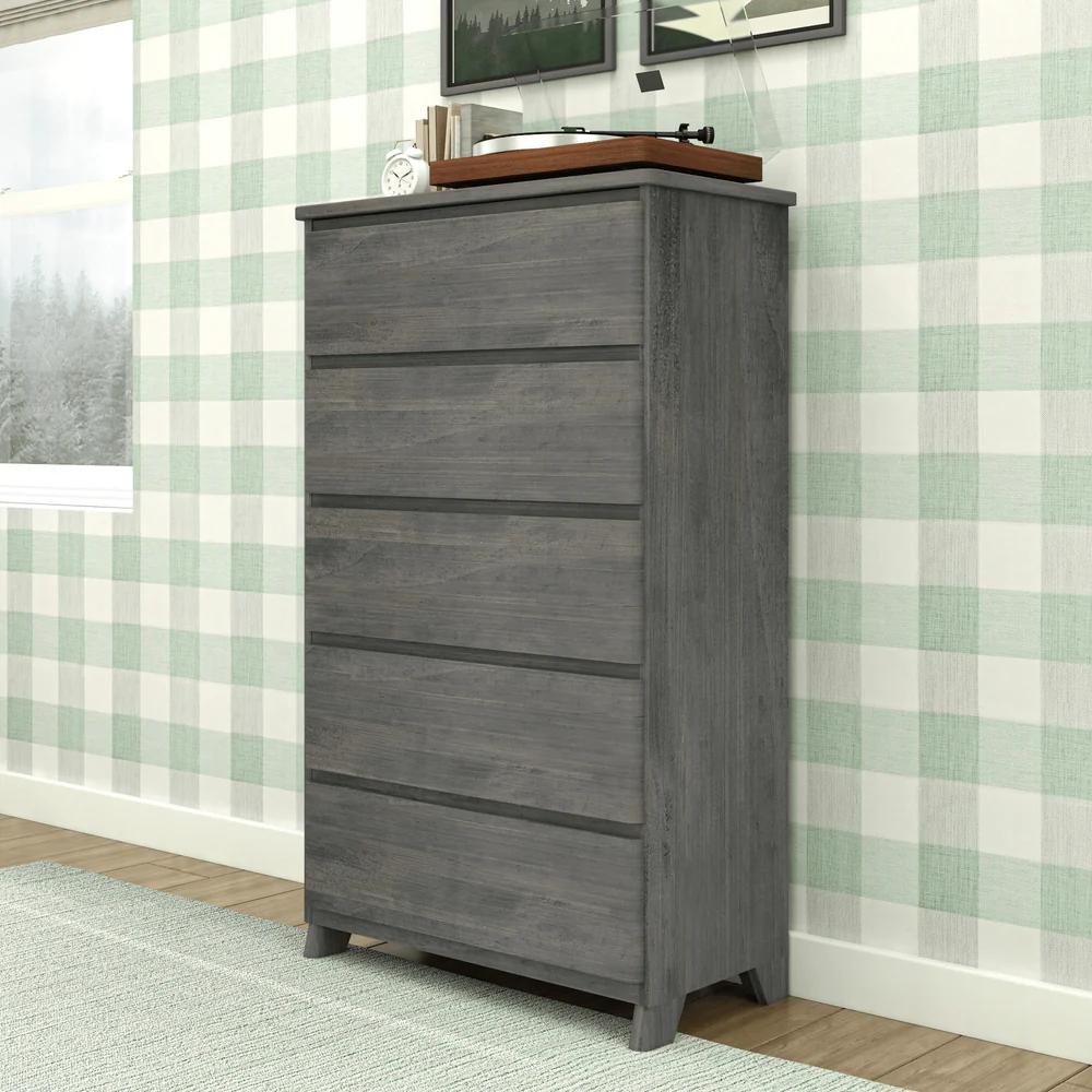 Max & Lily Modern Farmhouse 5 Drawer Dresser in Driftwood - angled view in a bedroom beside a window with a record player on top