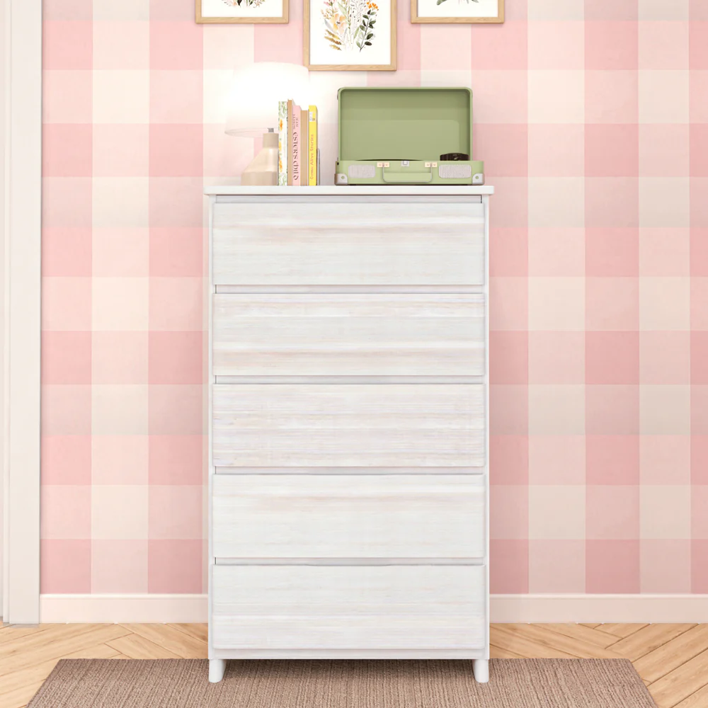 Max & Lily Modern Farmhouse 5 Drawer Dresser in White Wash - styled in a pink gingham bedroom with a lamp, books, and record player on top