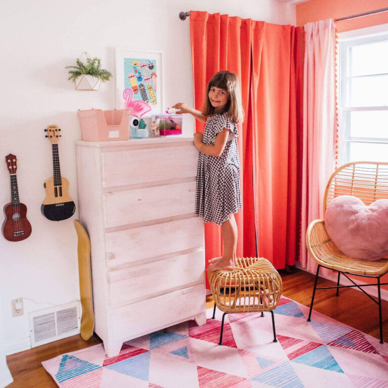 Max Lily Modern Farmhouse 5 Drawer Dresser White Wash Room Scene 8 Max & Lily Modern Farmhouse 5 Drawer Dresser in White Wash - a child decorating the top of the dresser in a bright, colourful bedroom
