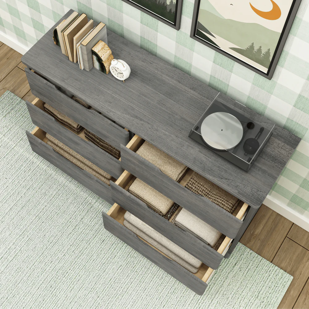 Max & Lily Modern Farmhouse 6 Drawer Dresser in Driftwood - overhead view with drawers pulled open revealing folded linens and storage baskets inside.