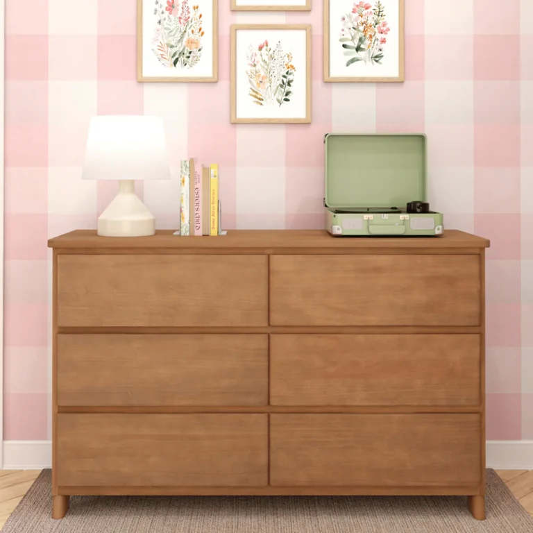 Max Lily Modern Farmhouse 6 Drawer Dresser Pecan Room Scene Max & Lily Modern Farmhouse 6 Drawer Dresser in Pecan - styled in a kids' bedroom with a table lamp, books, and record player against a pink gingham wall with framed floral art.