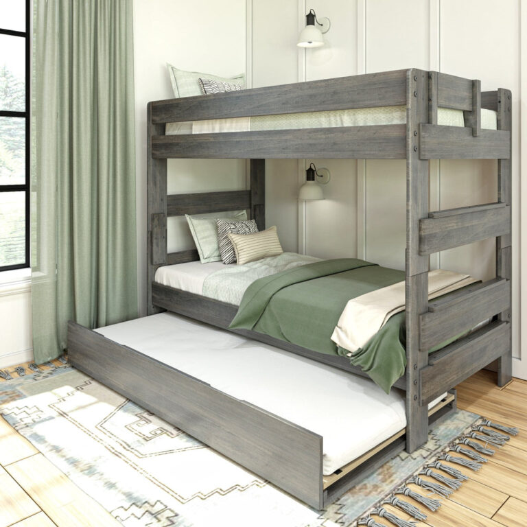 Max & Lily Modern Farmhouse Twin Over Twin Bunk Bed With Trundle in Driftwood - styled bedroom with the pull-out trundle extended beneath the lower bunk and green curtains at the window.