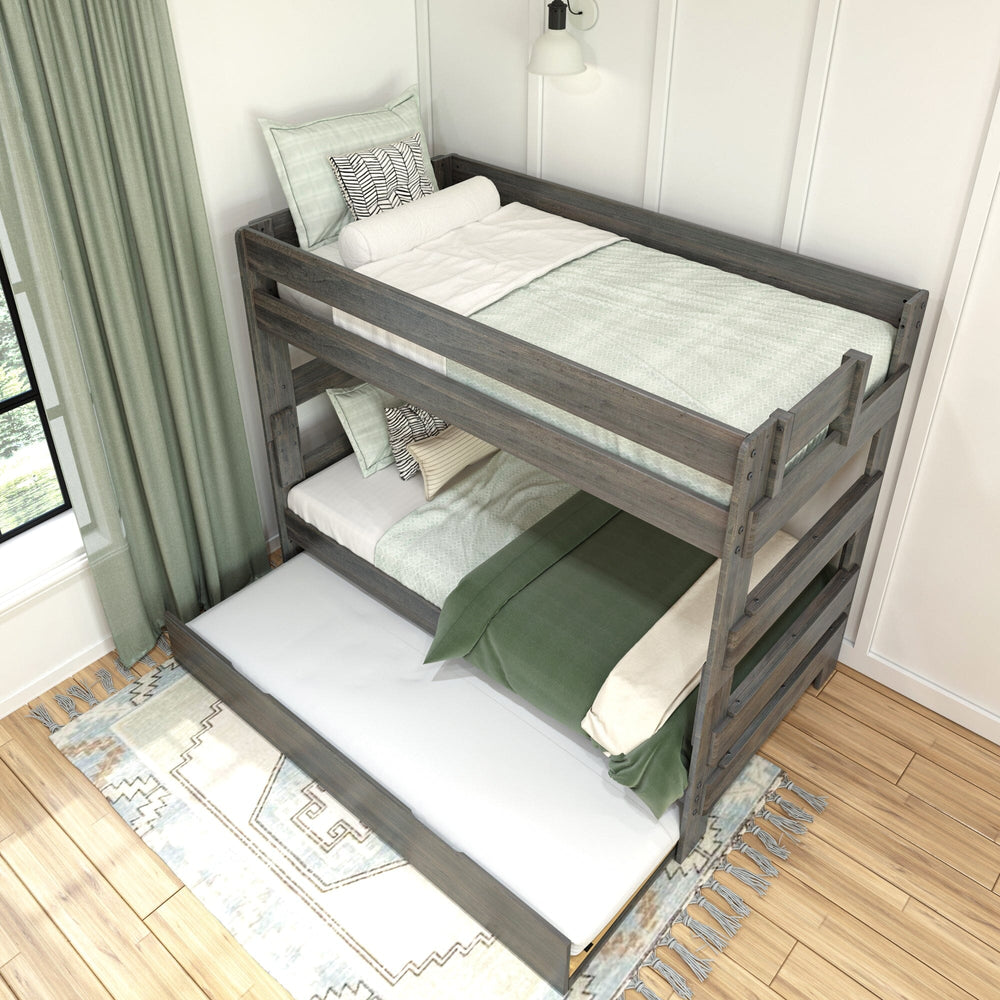 Max & Lily Modern Farmhouse Twin Over Twin Bunk Bed With Trundle in Driftwood - overhead angled view in a styled bedroom with the trundle pulled out onto the rug.