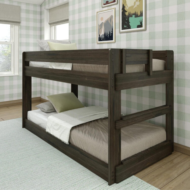 Max & Lily Modern Farmhouse Twin Over Twin Low Bunk Bed in Barnwood Brown - angled view of the low-height bunk bed styled in a bedroom with green gingham walls and framed art.