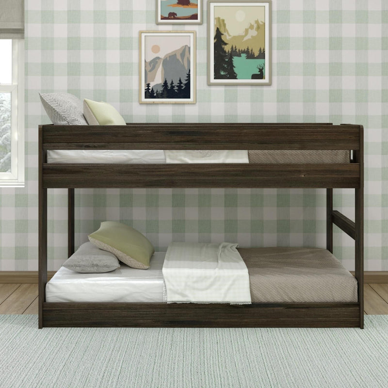 Max & Lily Modern Farmhouse Twin Over Twin Low Bunk Bed in Barnwood Brown - front view of the low bunk bed with both twin mattresses in a decorated bedroom.