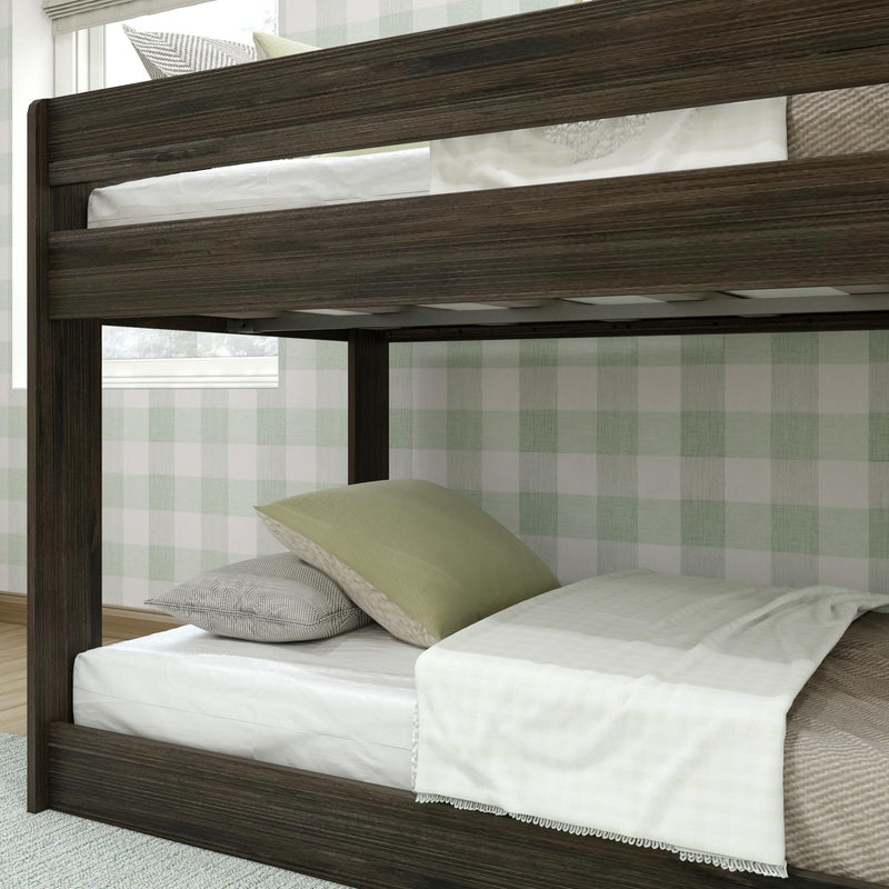Max & Lily Modern Farmhouse Twin Over Twin Low Bunk Bed in Barnwood Brown - close-up of the upper bunk guardrail and the low clearance between the two mattresses.