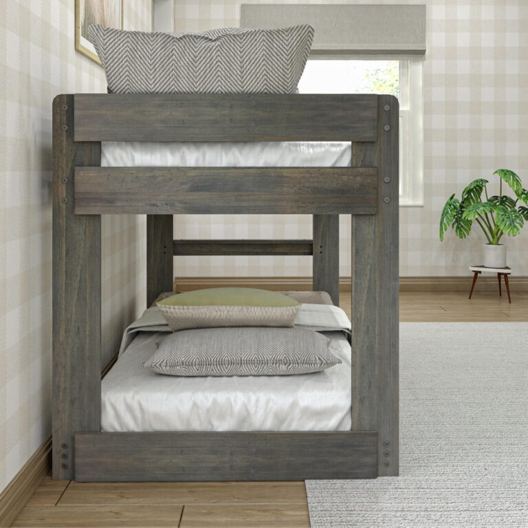 Max & Lily Modern Farmhouse Twin Over Twin Low Bunk Bed in Driftwood - end view showing the built-in ladder between the two bunks in a bedroom with a potted plant.