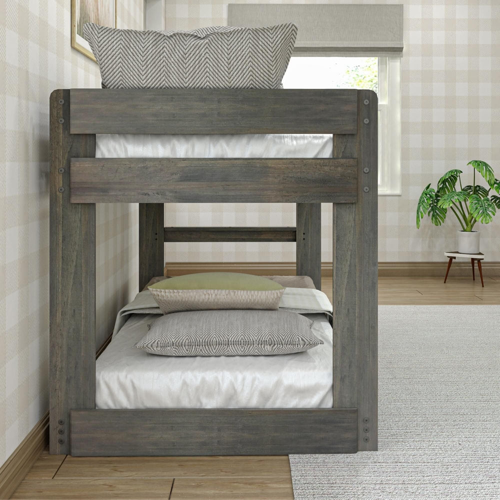 Max & Lily Modern Farmhouse Twin Over Twin Low Bunk Bed in Driftwood - end view showing the built-in ladder between the two bunks in a bedroom with a potted plant.
