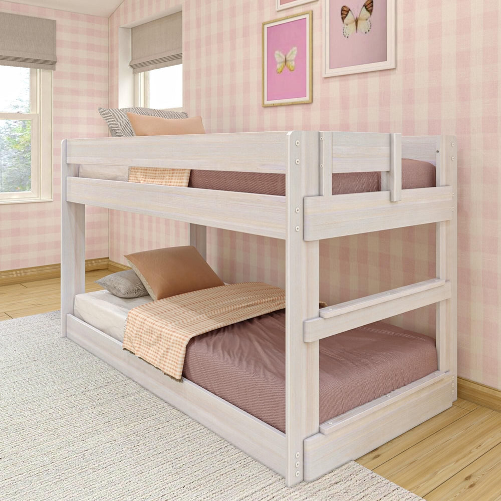 Max & Lily Modern Farmhouse Twin Over Twin Low Bunk Bed in White Wash - angled room scene styled with bedding and pillows in a pink gingham bedroom with butterfly wall art