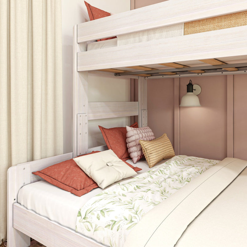Max & Lily Modern Farmhouse Twin XL-Over-Queen Bunk Bed in White Wash - close-up of the lower queen bunk with decorative pillows and the top bunk's wooden slats overhead
