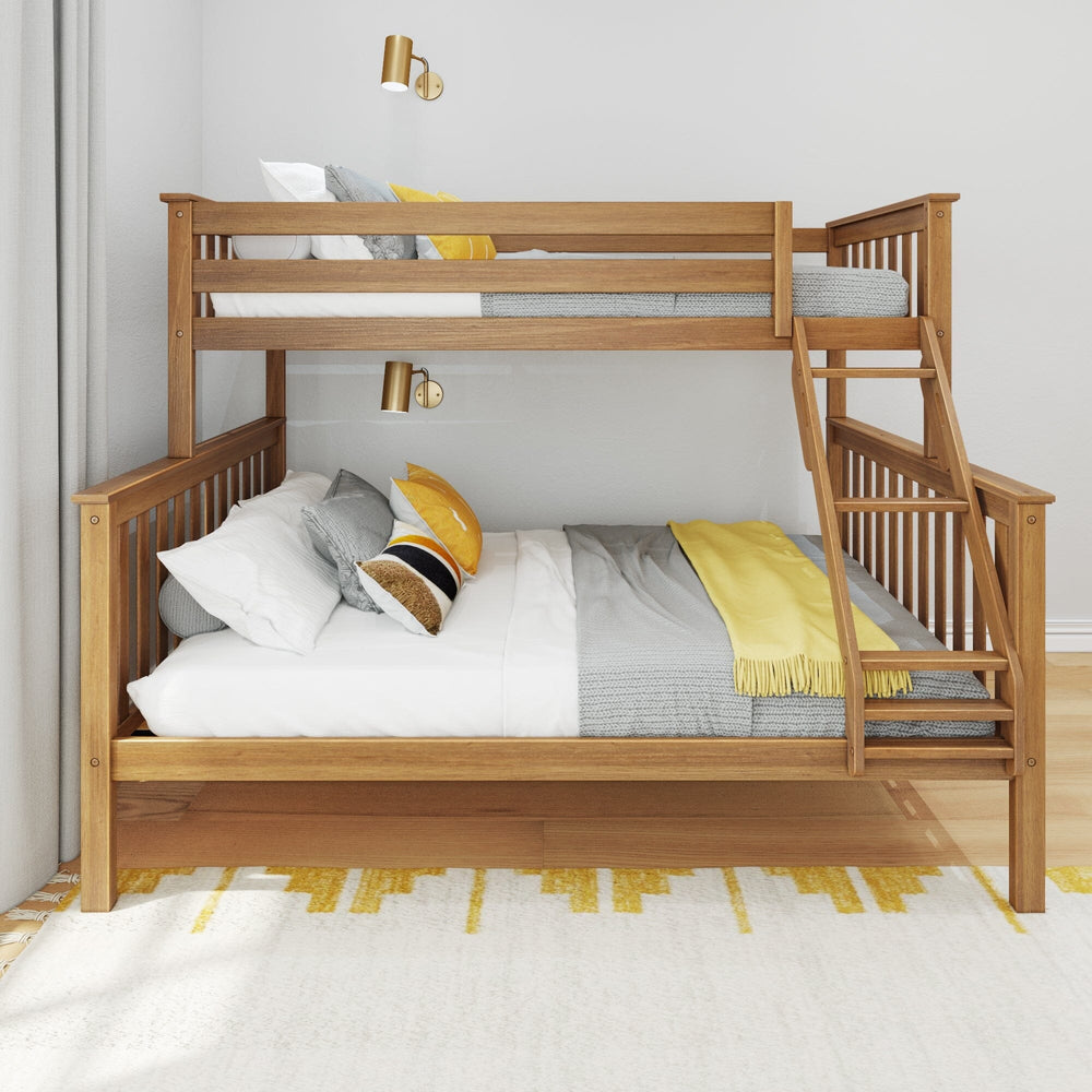 Max & Lily Twin XL-Over-Queen Bunk Bed in Pecan - front view styled in a bedroom with white and grey bedding, pillows, and a wall sconce