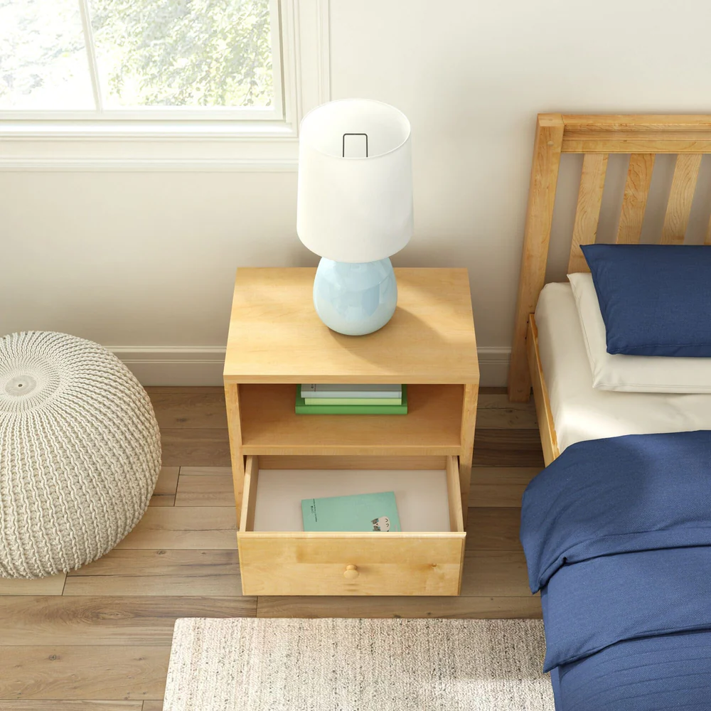 Maxtrix 1 Drawer Nightstand in Natural - overhead bedroom scene beside a bed, with the drawer open to reveal a book inside and a lamp on top