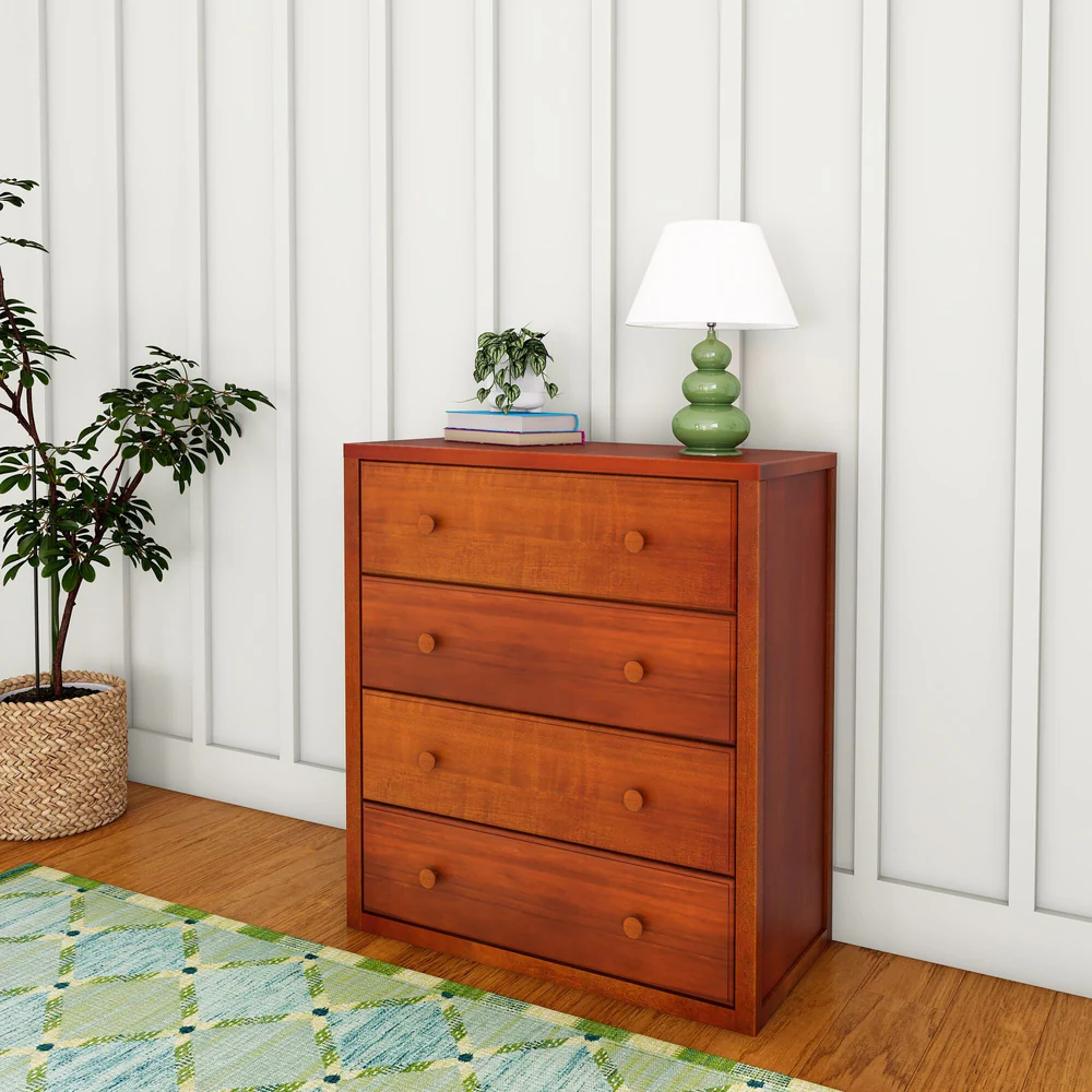 Maxtrix 4 Drawer Dresser Chestnut Room Scene Maxtrix 4 Drawer Dresser in Chestnut - angled view in a bedroom with a lamp, plant and books styled on top